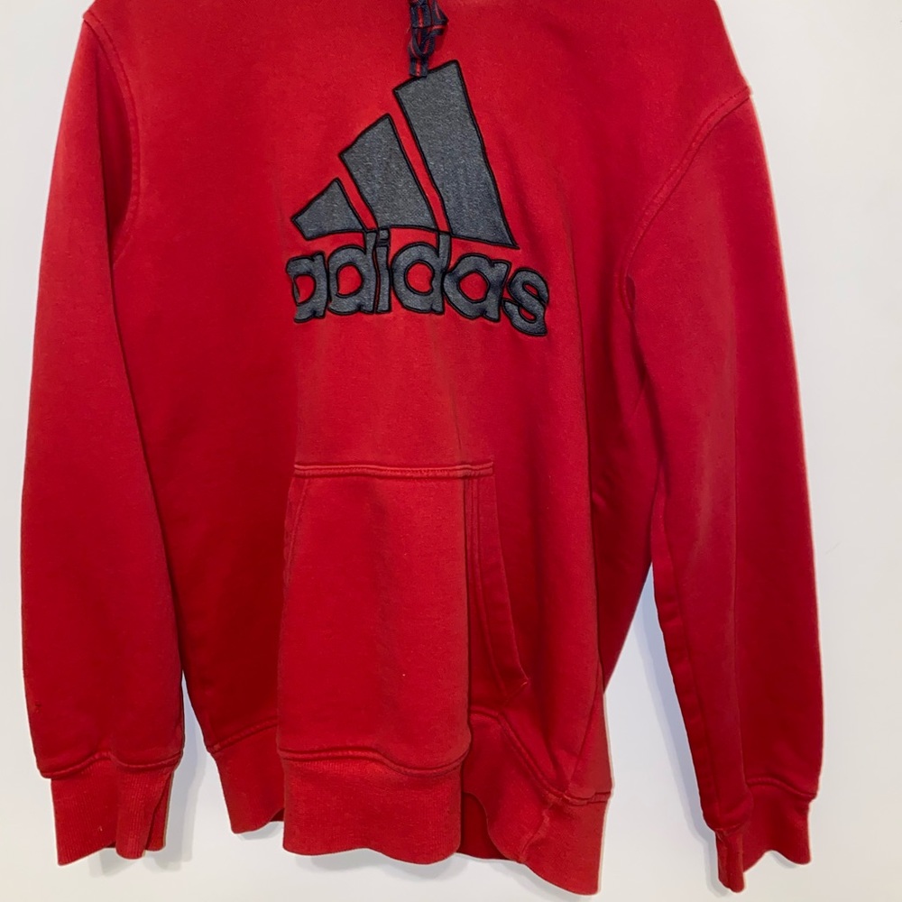 A red and grey adidas hoodie.